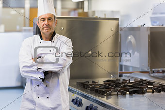 Cook with arms crossed standing in the kitchen