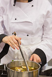 Chef stirring soup