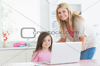 Woman and child in the kitchen smiling