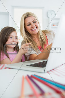 Woman and girl at the laptop and pointing