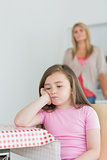 Little girl sitting looking exasperated