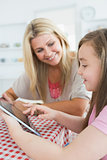 Woman and daughter holding a tablet pc