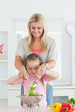 Woman and child mixing salad together