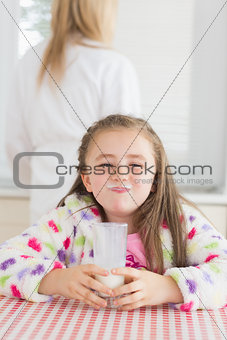 Little girl with milk moustache
