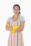 Smiling woman wearing rubber gloves and apron