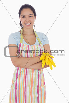 Woman holding gloves and wearing an apron
