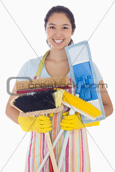 Woman holding mops and brushes