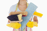 Woman holding brushes and mops
