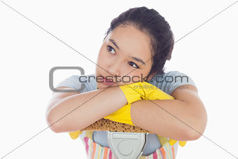 Troubled woman leaning on a mop