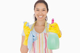 Smiling woman holding up spray bottle