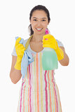 Smiling woman holding out spray bottle
