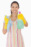 Happy woman holding out spray bottle