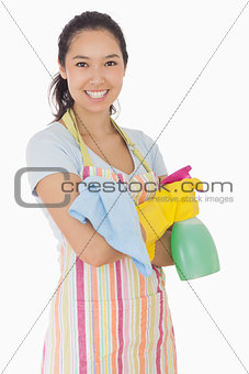 Happy woman holding cleaning products
