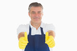 Man giving thumbs up in rubber gloves