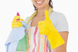 Woman giving thumbs up holding cleaning products