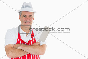 Smiling butcher with meat cleaver