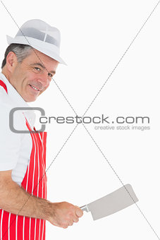 Butcher wielding meat cleaver and smiling