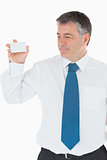 Smiling businessman showing card