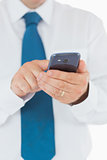 Man in shirt and tie using his smartphone