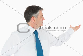 Businessman holding out hand to the right