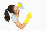 Happy woman pointing to white surface she is cleaning
