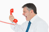 Angry businessman yelling at phone