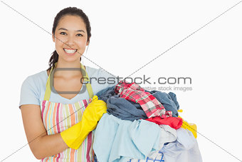 Laughing woman holding laundry basket