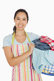 Smiling woman holding laundry basket