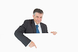 Smiling businessman pointing to board