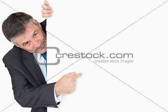 Man pointing to whiteboard and smiling