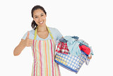 Woman carrying laundry basket and giving thumbs up