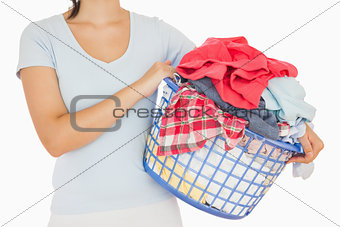 Brunette holding a basket full of laundry