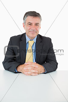 Happy man sitting at his desk