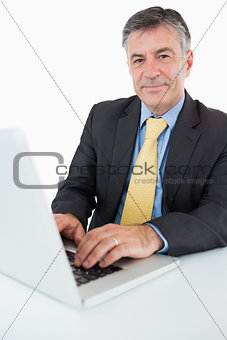 Happy man typing on his laptop