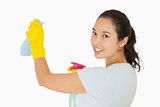 Smiling woman cleaning walls