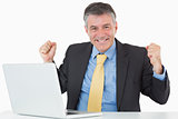 Succesful man sitting at his desk with laptop