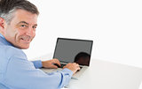 Smiling man working with laptop