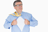 Serious man with glasses is pulling his shirt with his hands