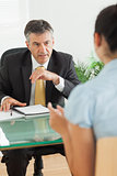 Businessman speaking with a woman in his office