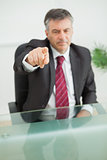 Serious businessman pointing