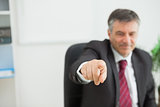 Smiling businessman pointing