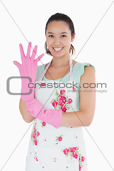 Woman putting on plastic gloves