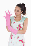 Woman pulling on rubber gloves
