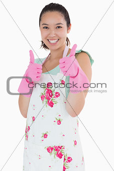 Woman wearing rubber gloves giving thumbs up