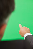 Man pointing to green screen