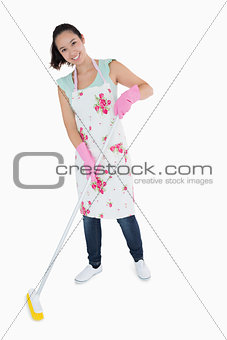 Happy woman sweeping floor