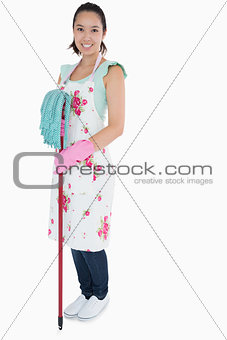 Woman with gloves apron and mop