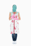 Woman in apron hiding her face with a mop