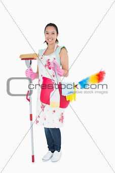 Woman holding cleaning tools