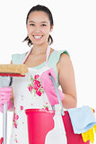 Happy woman holding different cleaning tools